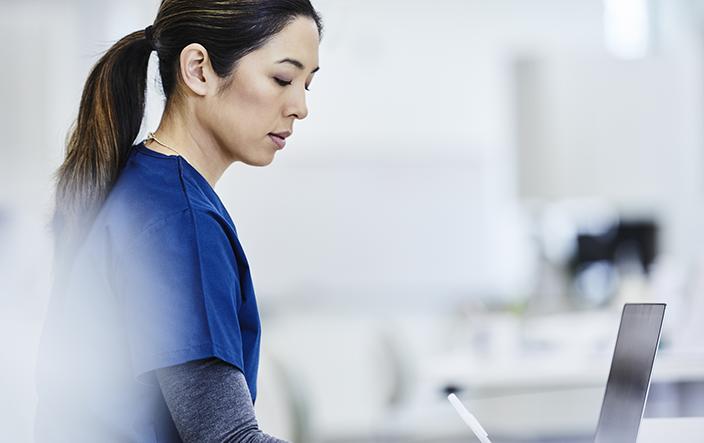 asian-woman-standing-near-computer-atwork