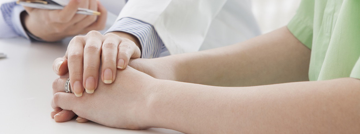 two-women-doctor-holding-hand-oncology-journey-oc